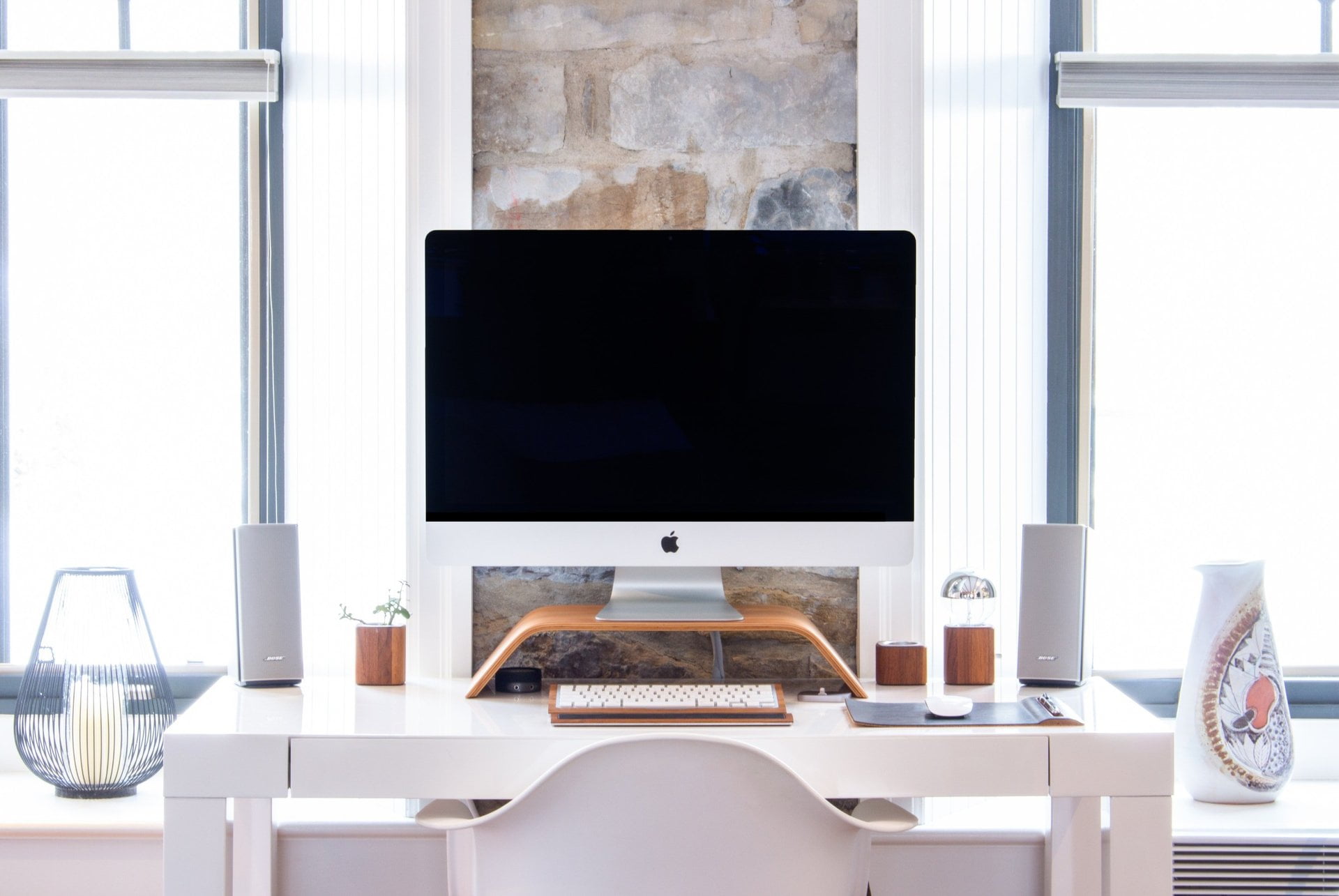 Mac monitor and keyboard on a desk
